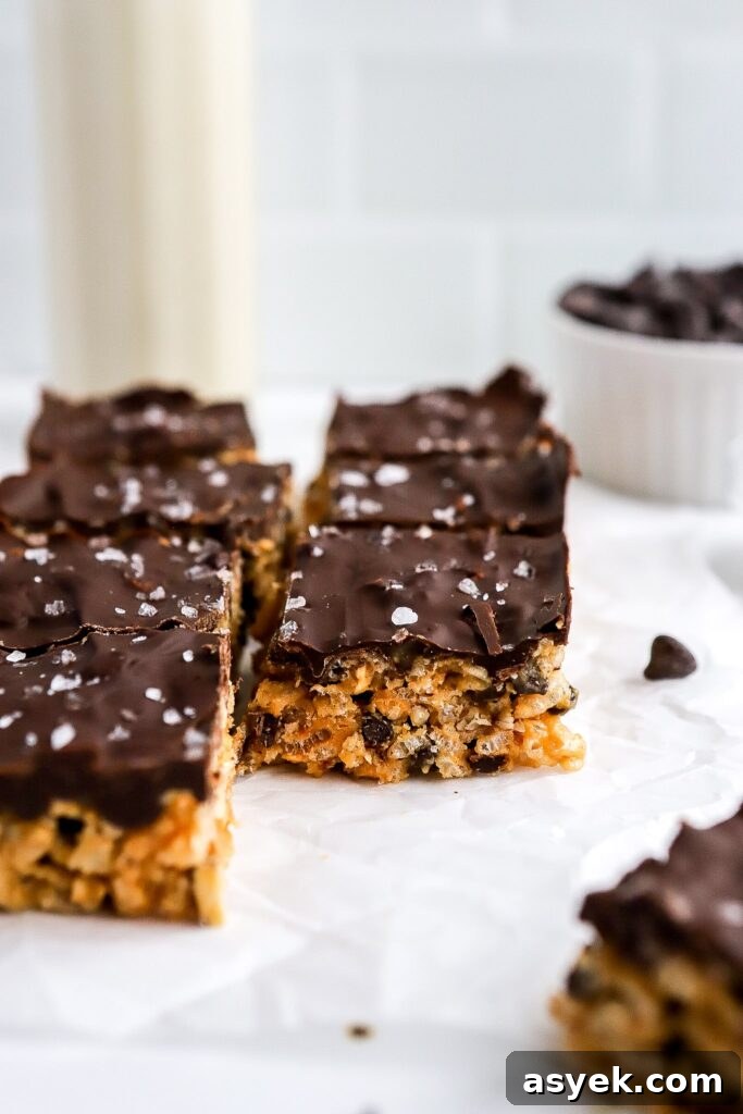dark chocolate layer on peanut butter rice krispie bars topped with flaky sea salt