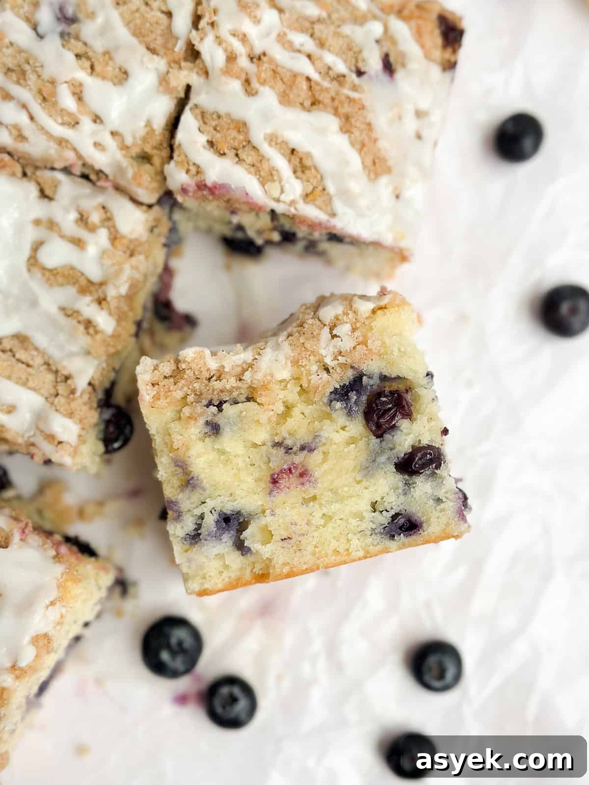 a slice of blueberry lemon crumb cake turned up to see inside.