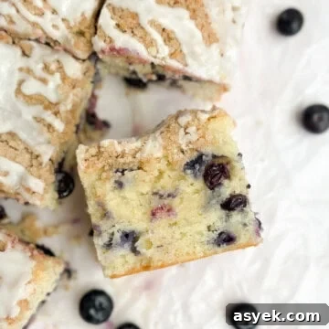 a slice of blueberry lemon crumb cake turned up to see inside.