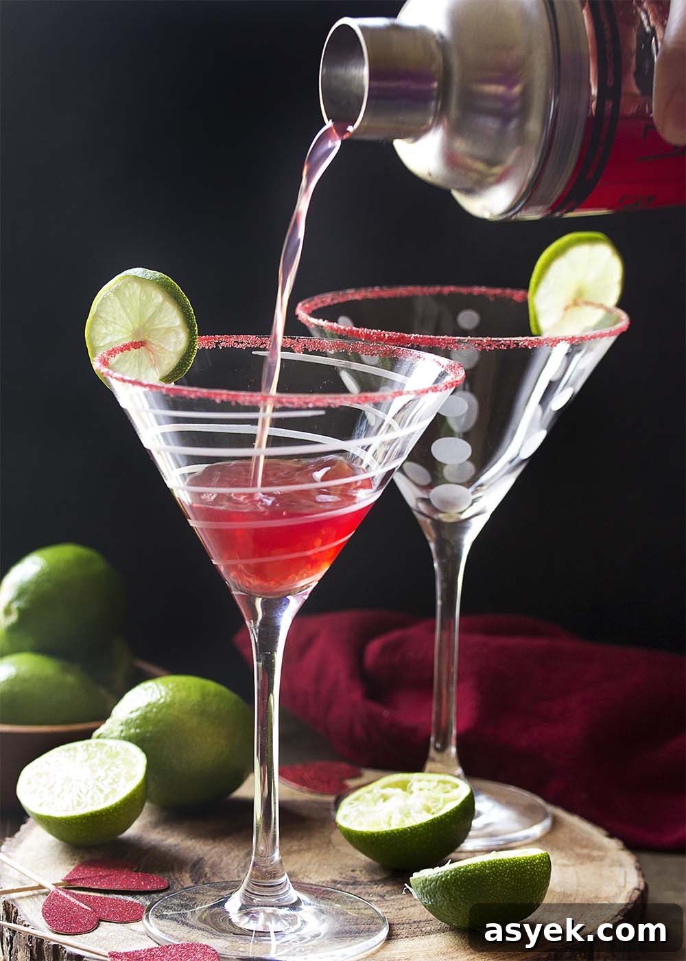 Pomegranate Vodka Martini Recipe: Classic Cocktail 3 Pouring the cocktail from a shaker into a martini glass.