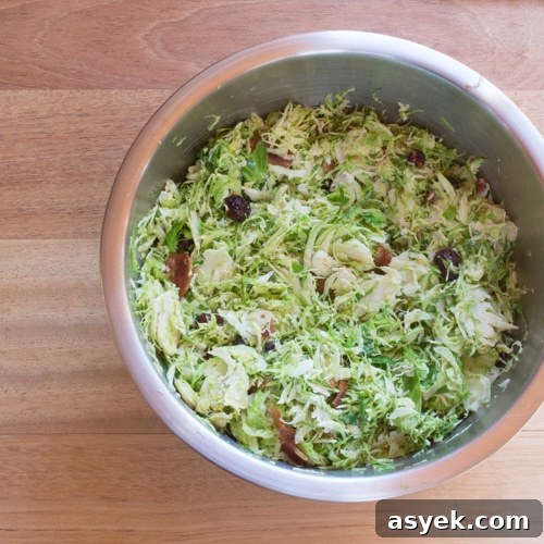 Brussels sprouts, dried cranberries, and quinoa ready for the oven.