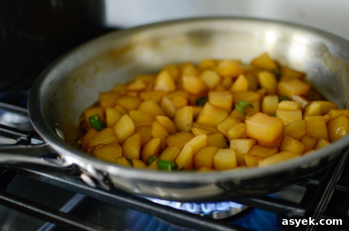 Korean Braised Potatoes (Gamja Jorim) Recipe 7 Potato cubes are braising in a soy sauce mixture to make gamja jorim.