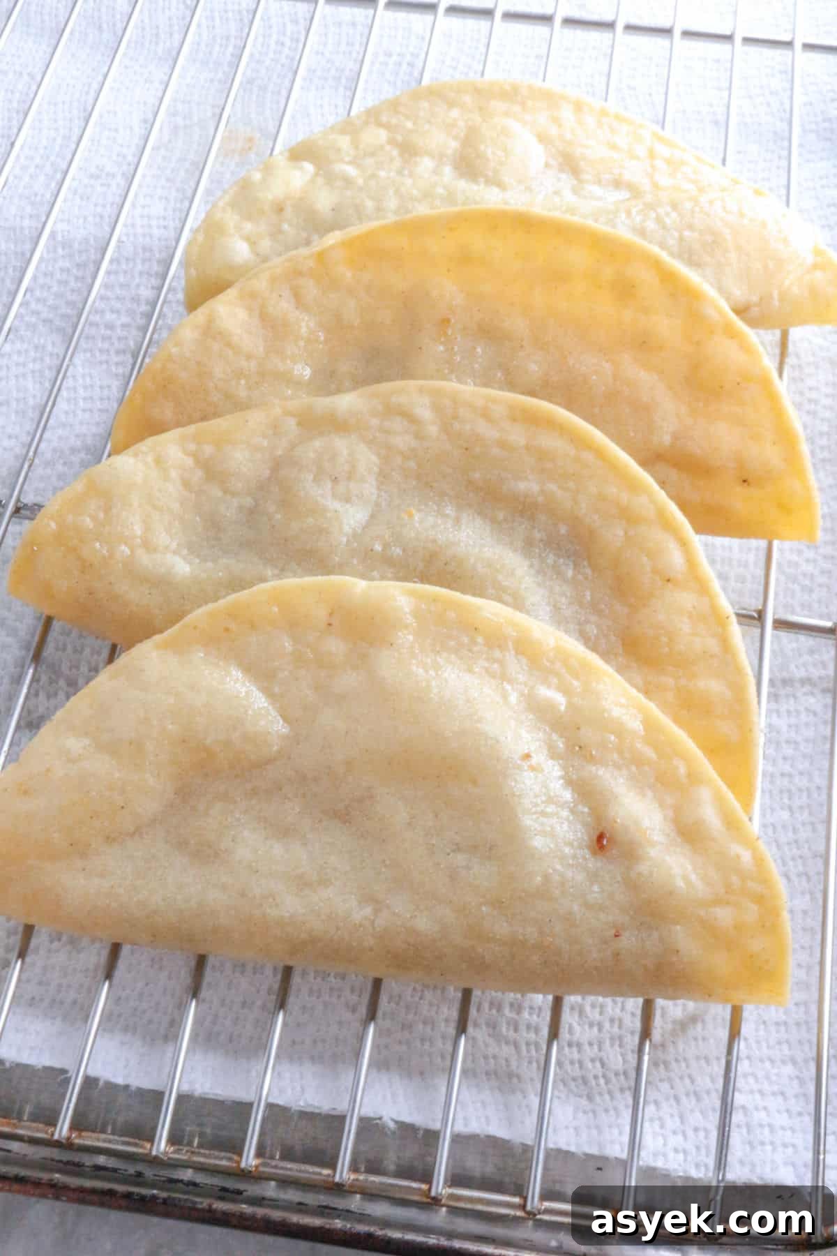 Crispy Mexican Bean Taco Recipe (Tacos Dorados) 8 Fried bean tacos draining on a wire rack
