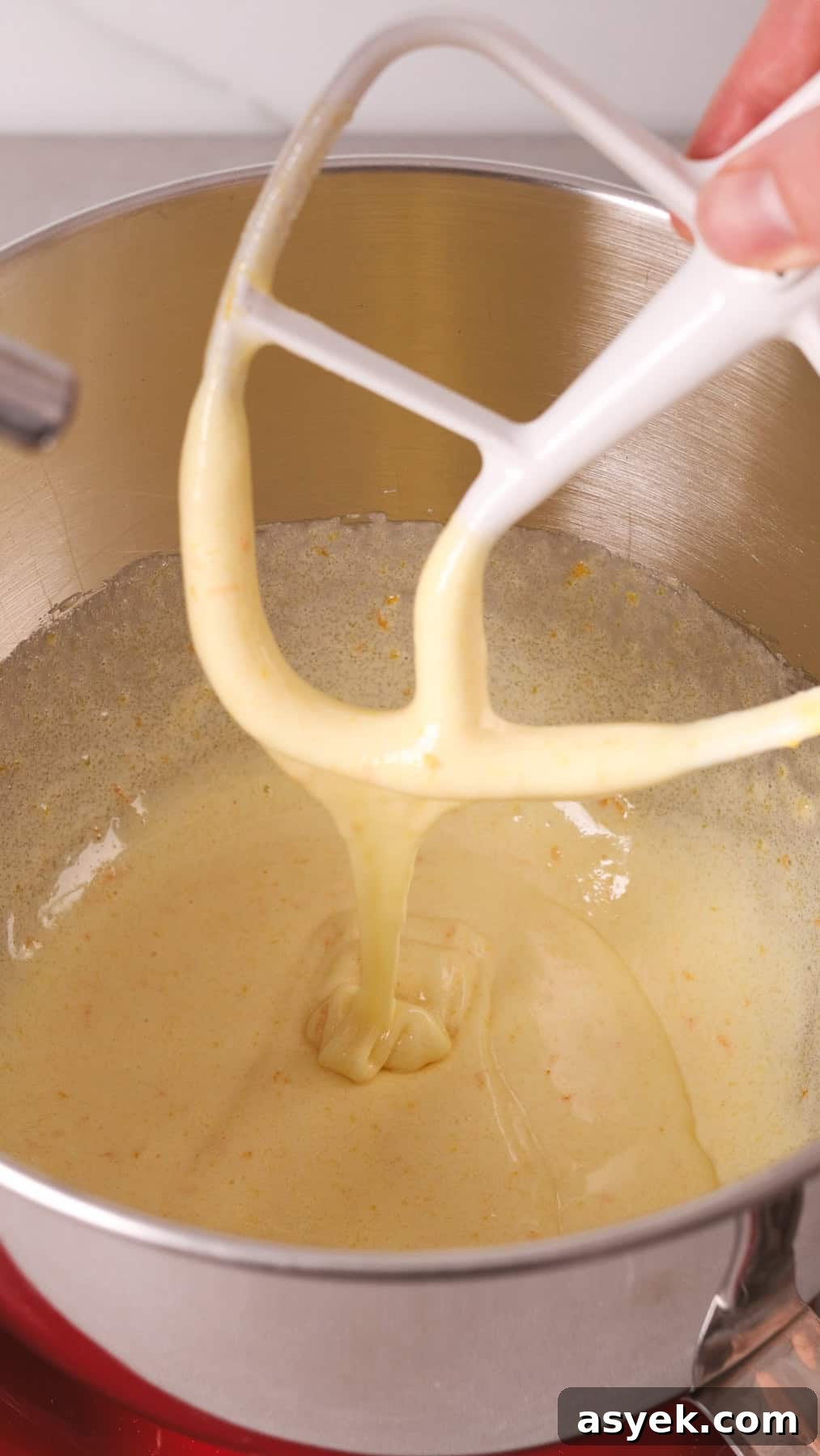 A pale and light and fluffy batter in a stand mixer.