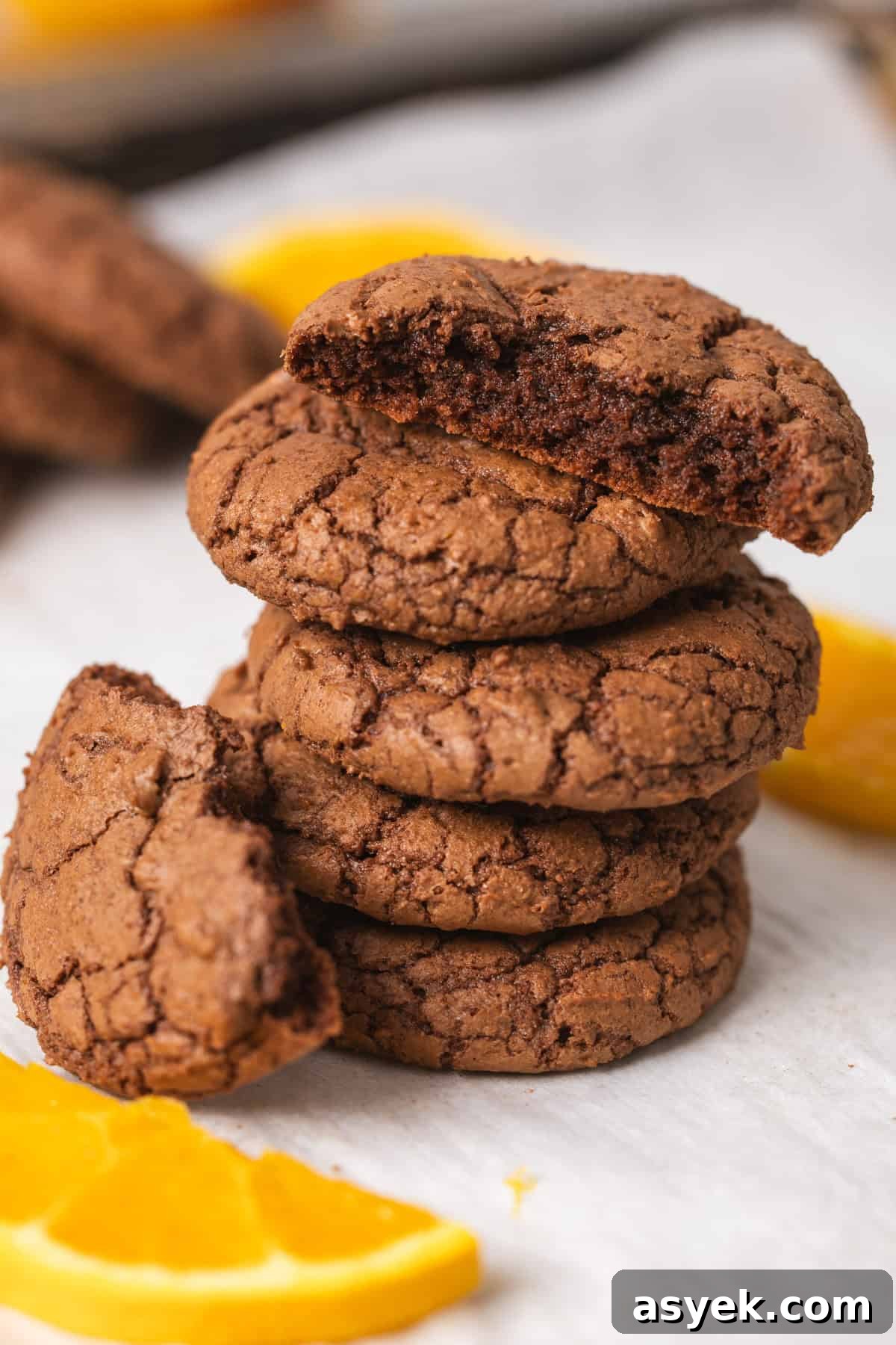 A close-up of a stack of chocolate and orange cookies.