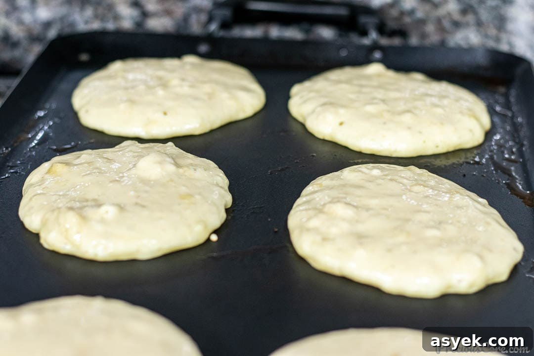 Banana Pancake Batter Cooking on Griddle
