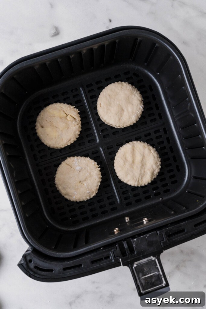 Buttery Air Fryer Biscuits in 15 Minutes 11 biscuits on the air fryer basket.