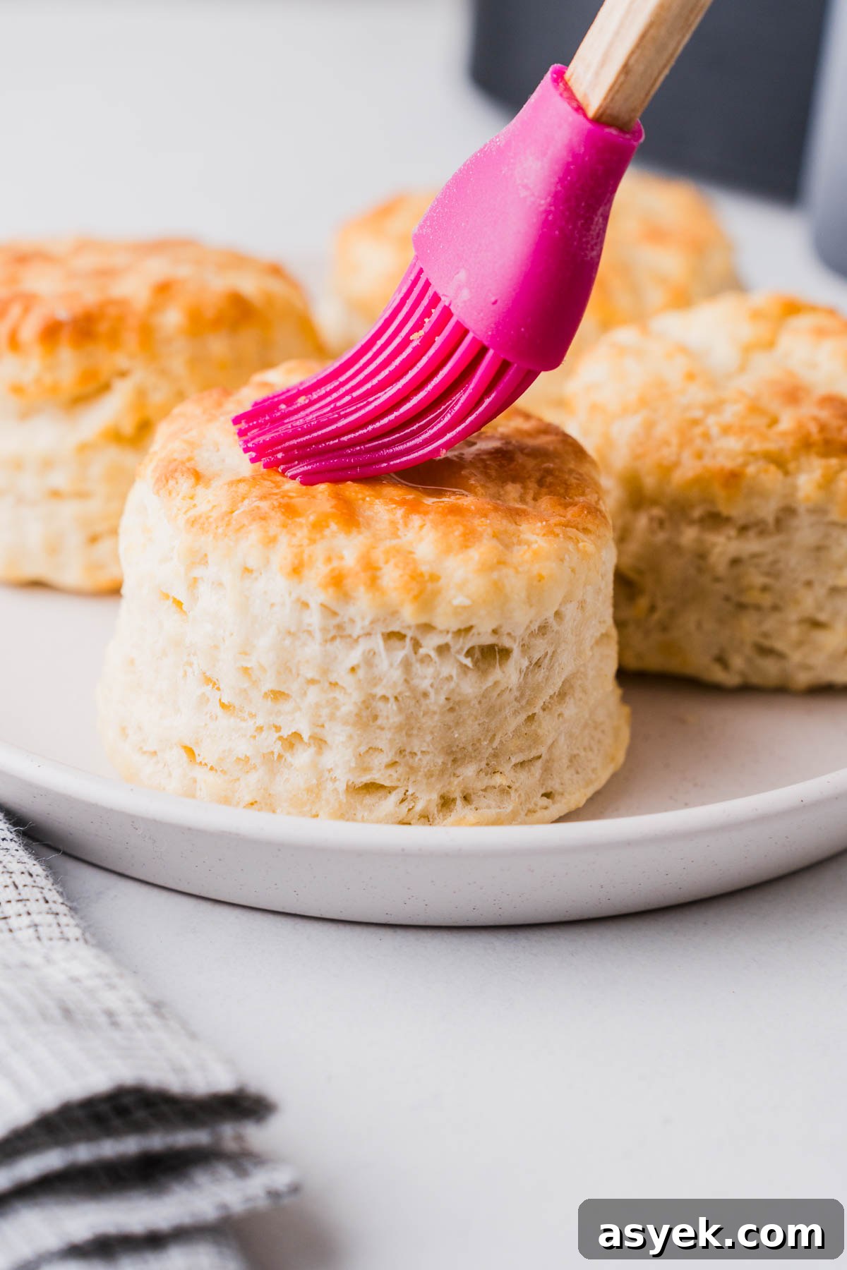 Buttery Air Fryer Biscuits in 15 Minutes 13 brushing oil on the air fryer biscuit with a brush.