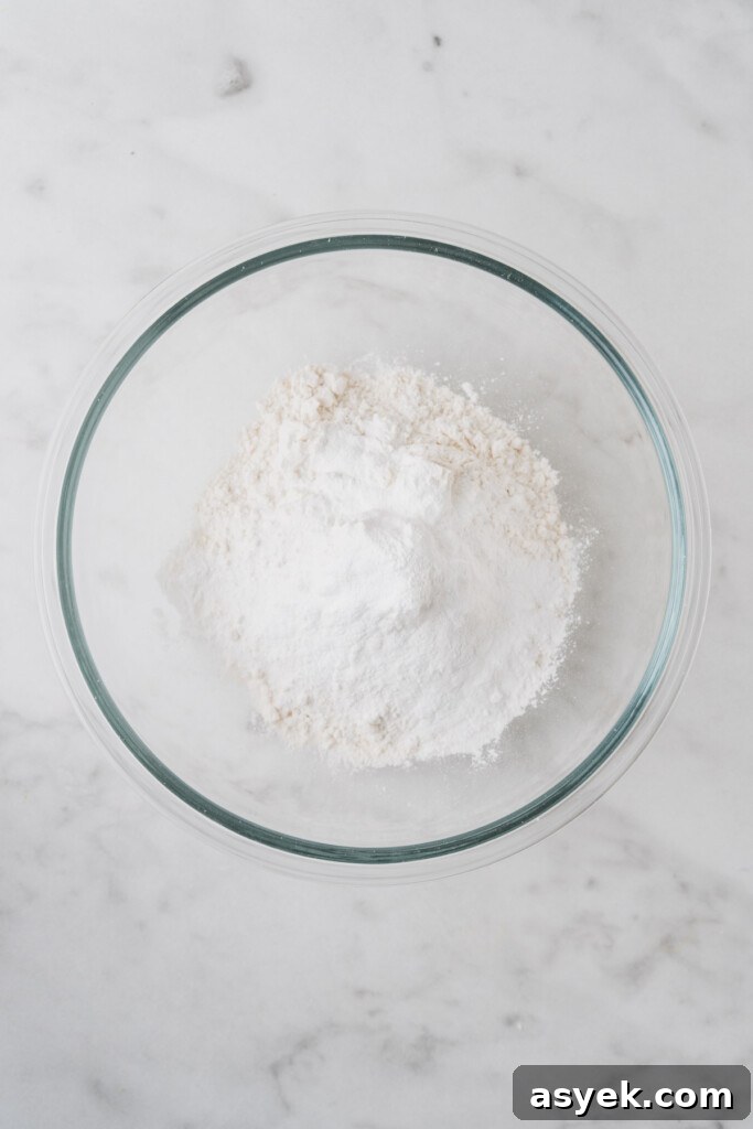 Buttery Air Fryer Biscuits in 15 Minutes 4 all purpose flour in a bowl on a white background.