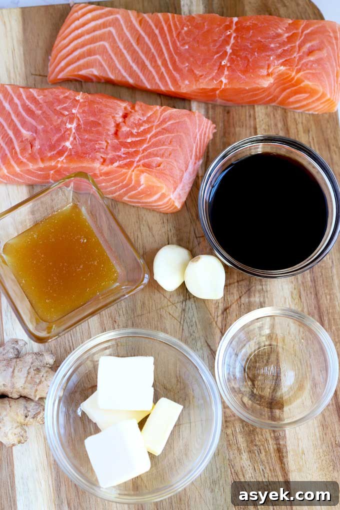Oven-Baked Honey Ginger Glazed Salmon Recipe 4 Ingredients to make Oven Baked Salmon with Honey Ginger Glade on a wooden board.