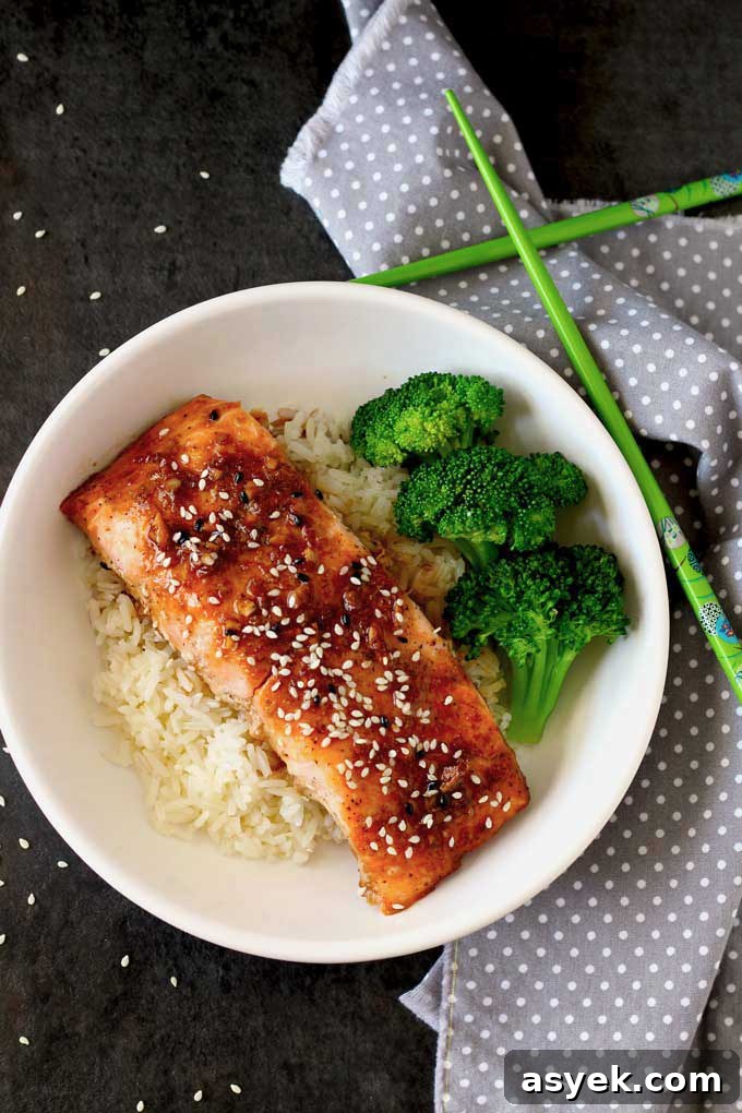 Oven-Baked Honey Ginger Glazed Salmon Recipe 5 Top view of oven baked salmon with honey ginger glazed on a bed of rice served with broccoli.