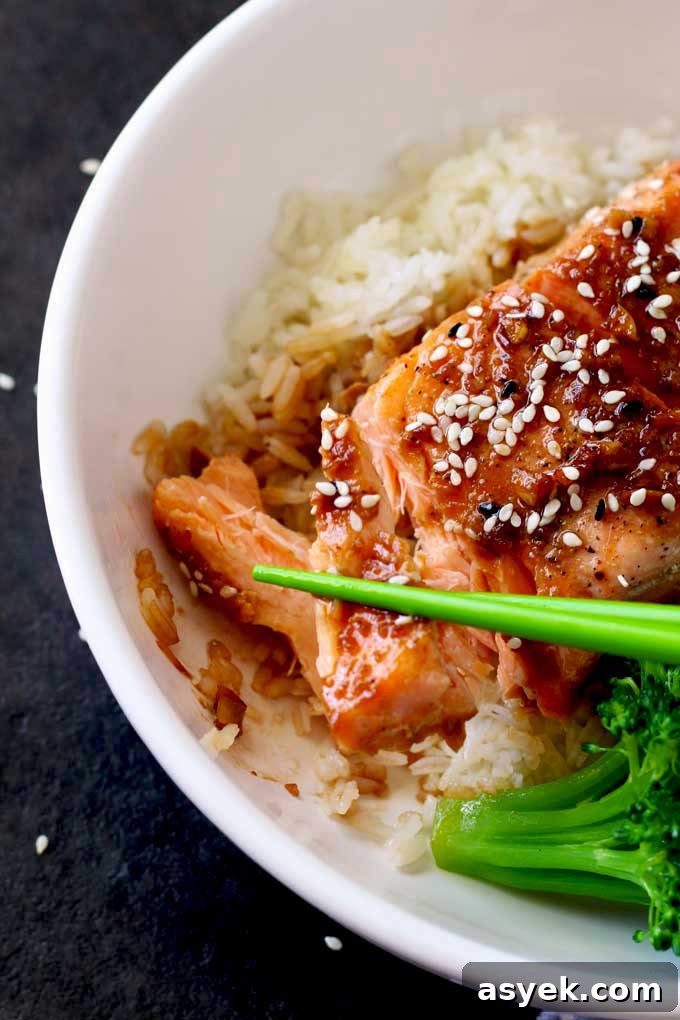 Oven-Baked Honey Ginger Glazed Salmon Recipe 7 Flaked salmon fillet lift with chopsticks.