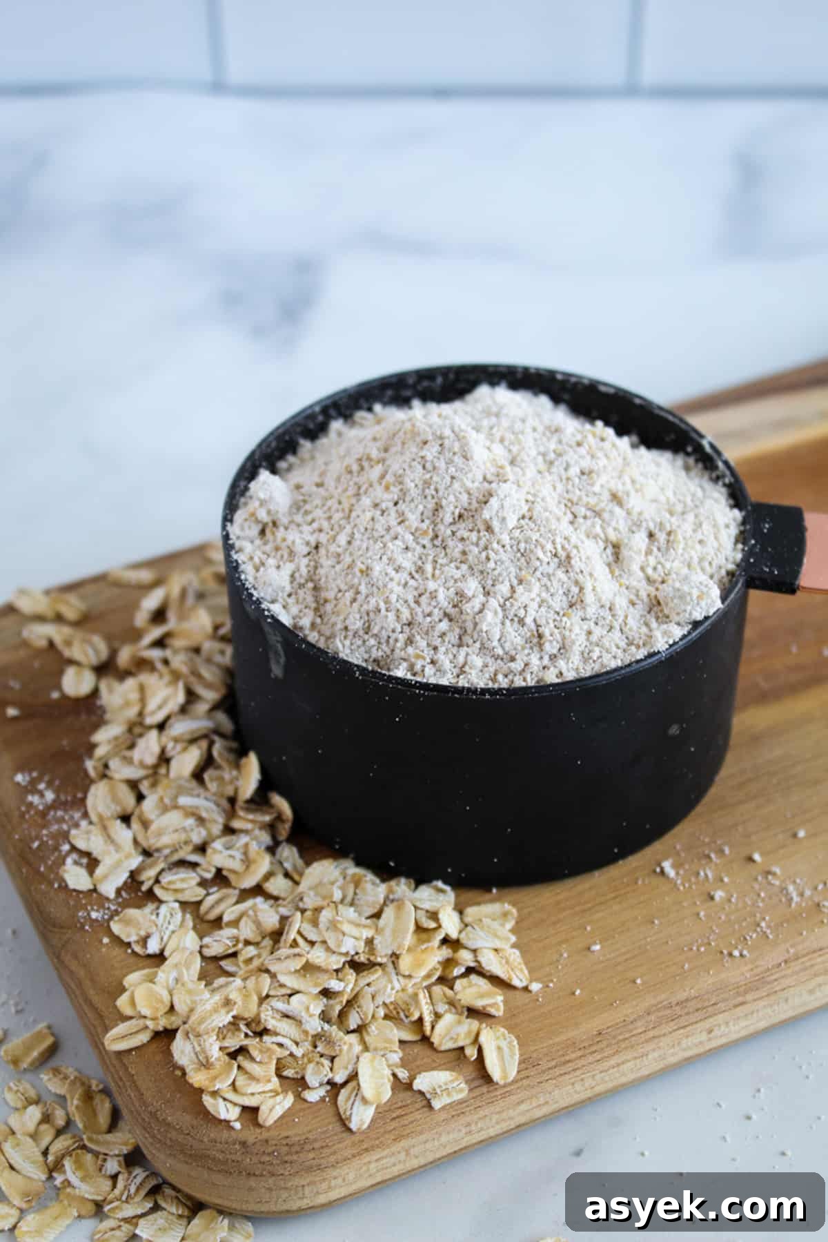 Almond Flour Substitutes: 10 Alternatives and How to Use Them 3 black cup of oat flour on a cutting board