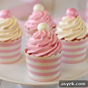 4 Strawberry Cupcakes with Italian Meringue Buttercream on a white cake plate.