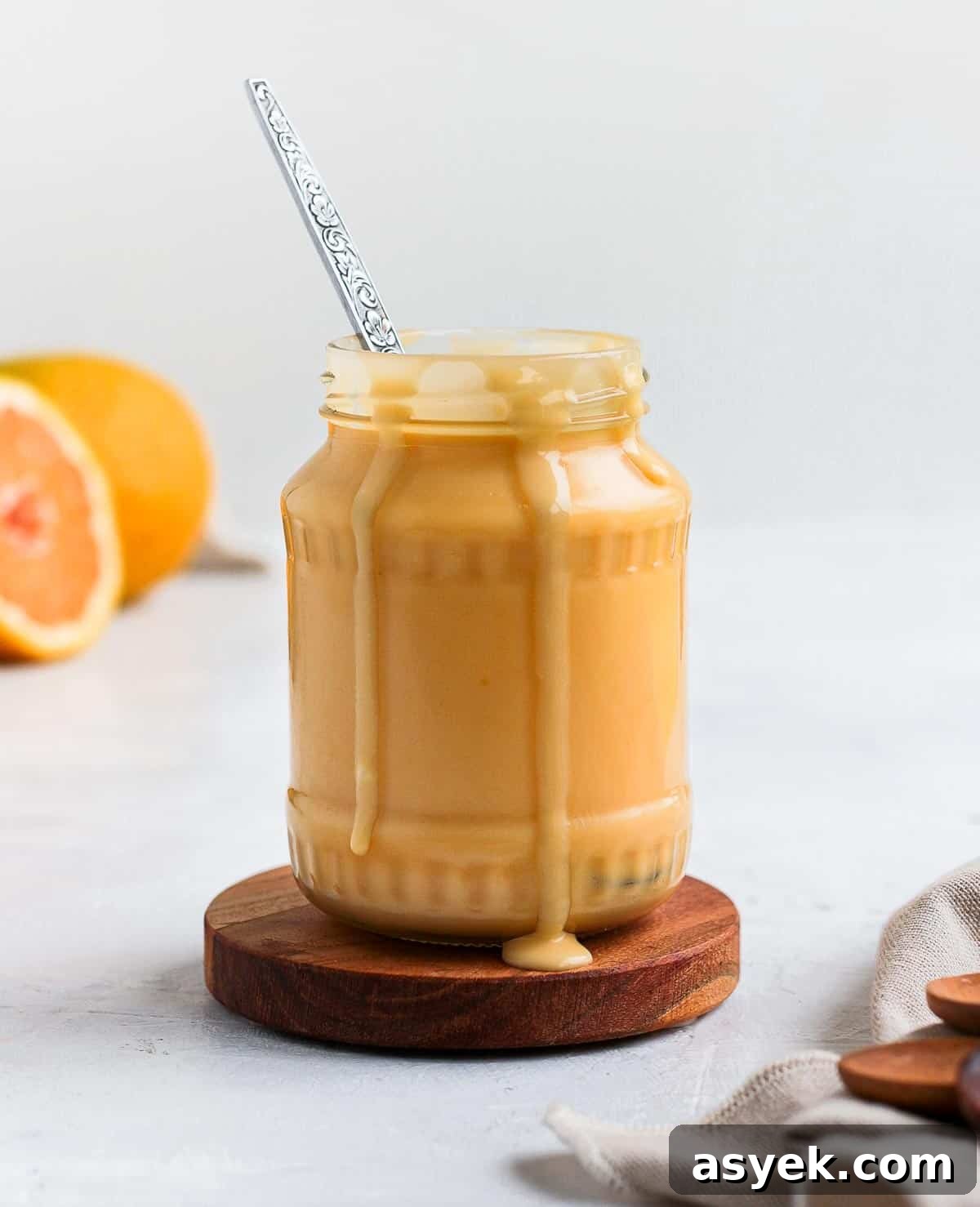 Curd in a glass jar with a spoon