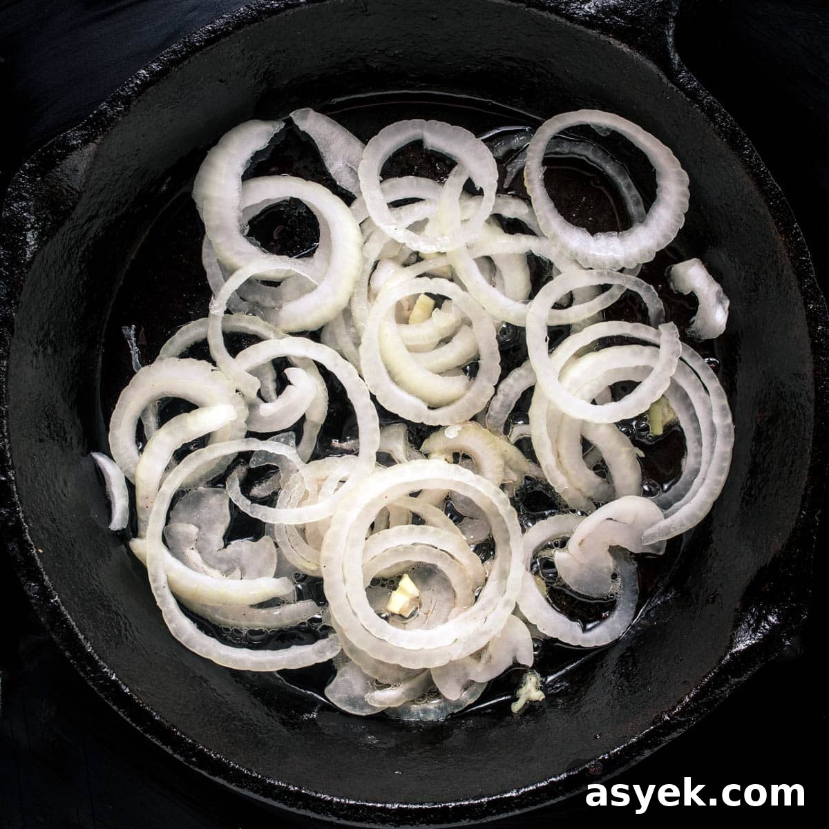 Sautéing the onions in a skillet to make haluski.