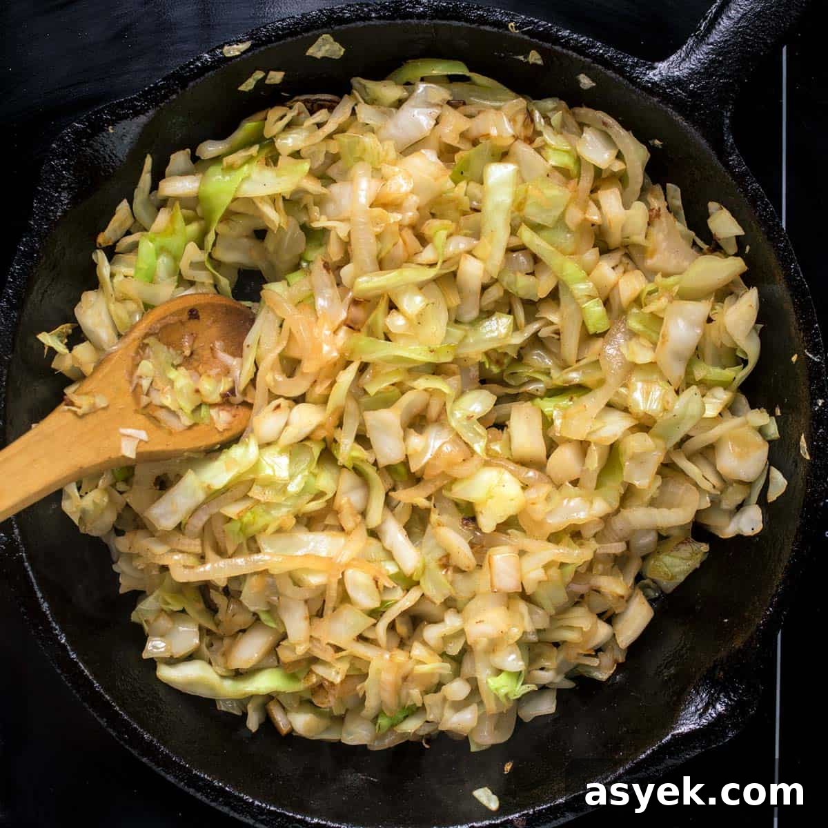 Frying the cabbage for haluski in a cast-iron skillet.