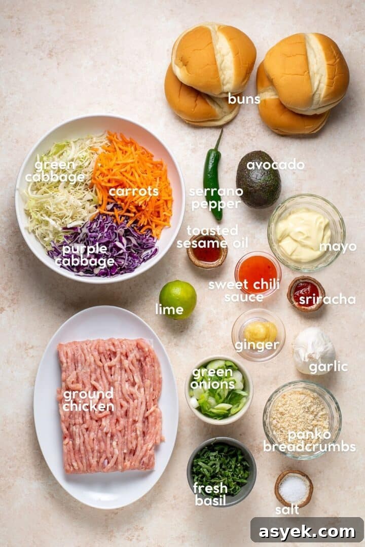 ingredients for sweet chili ground chicken burgers including ground chicken, cabbage, carrots, green onions, garlic, ginger, lime, sesame oil, mayo, sweet chili sauce, sriracha, panko breadcrumbs, basil, avocado, serrano pepper and buns