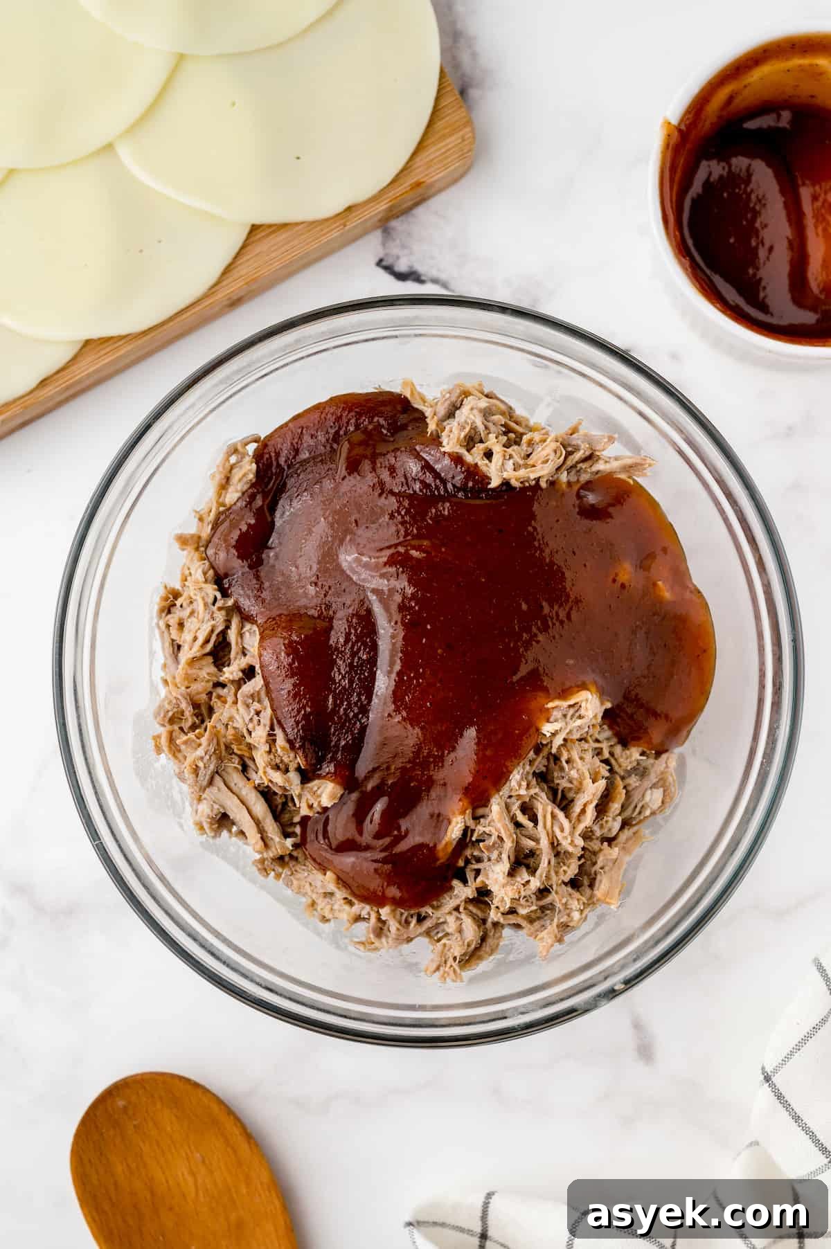 BBQ Pulled Pork Sliders on Hawaiian Rolls Recipe 5 Shredded pork in a large bowl topped with barbecue sauce.