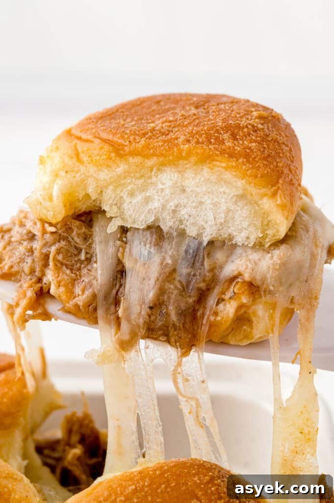 BBQ Pulled Pork Sliders on Hawaiian Rolls Recipe 9 A cheesy bbq pulled pork slider on a spatula.