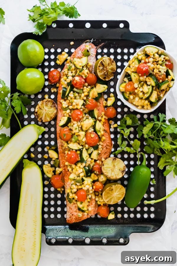 An overhead image of grilled salmon on a pan with vegetable relish on top.