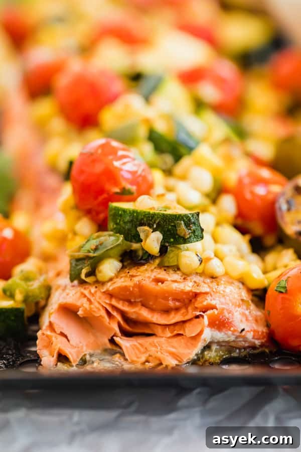 A close-up of the grilled salmon with a piece cut to reveal the inside.