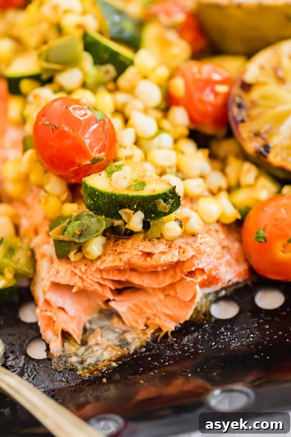 Close image of grilled salmon with pieces flaked off.