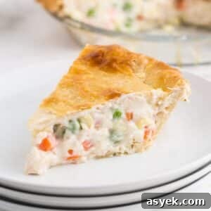 A slice of creamy chicken pot pie on a small white plate.