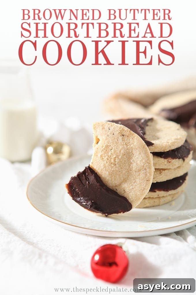 Irresistible Brown Butter Shortbread Cookies Recipe 9 A bitten into Shortbread Brown Butter Cookies sits on a white plate