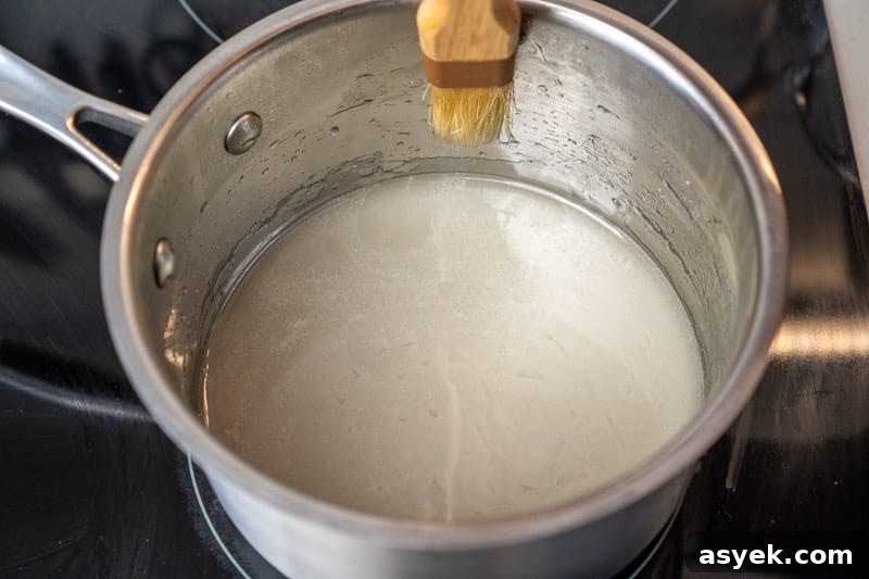 Brushing down the sides of the pan