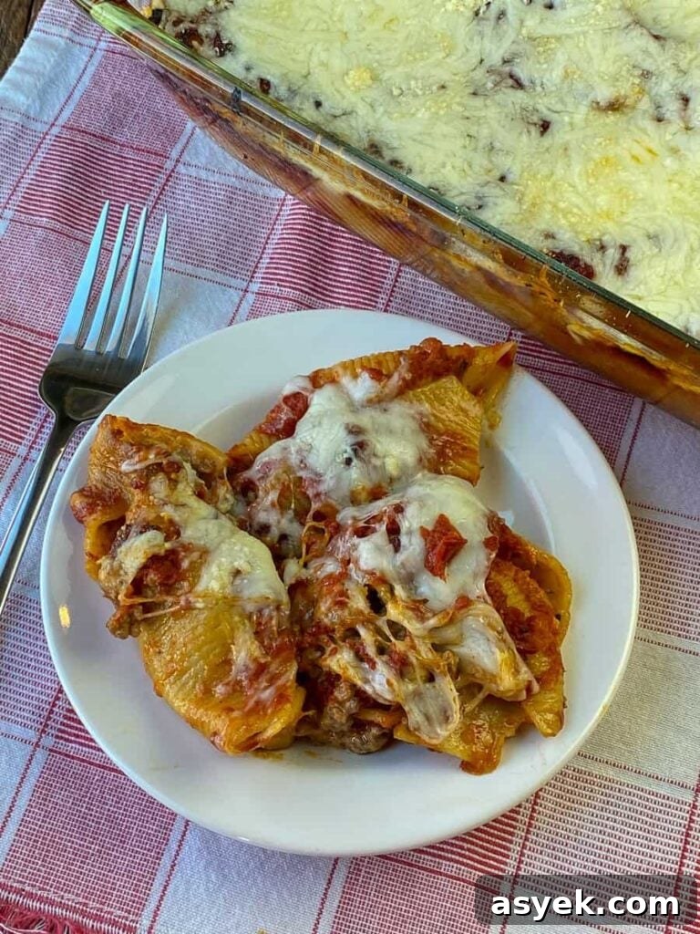 Plate of the best cream cheese and ground beef stuff shells on a red plaid napkin