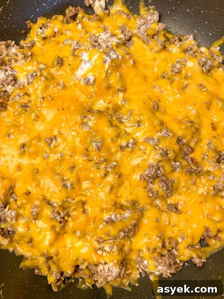 Sharp cheddar cheese melted on hamburger and cream cheese mixture