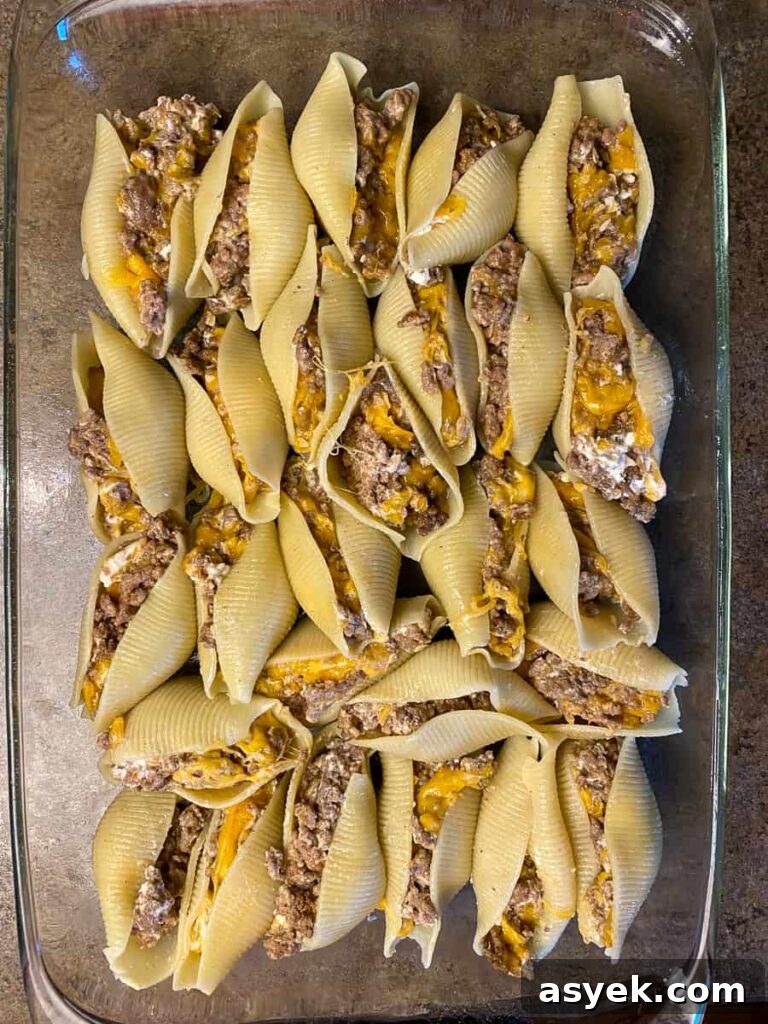 Large pasta shells stuffed with beefy, cheesy mixture in 9x13 dish