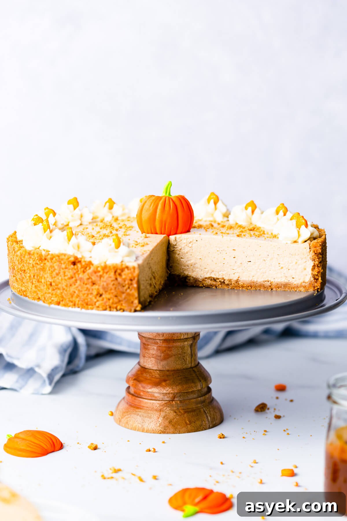 Creamy No-Bake Pumpkin Cheesecake Recipe 14 straight ahead close up at no bake pumpkin cheesecake on a small cake stand
