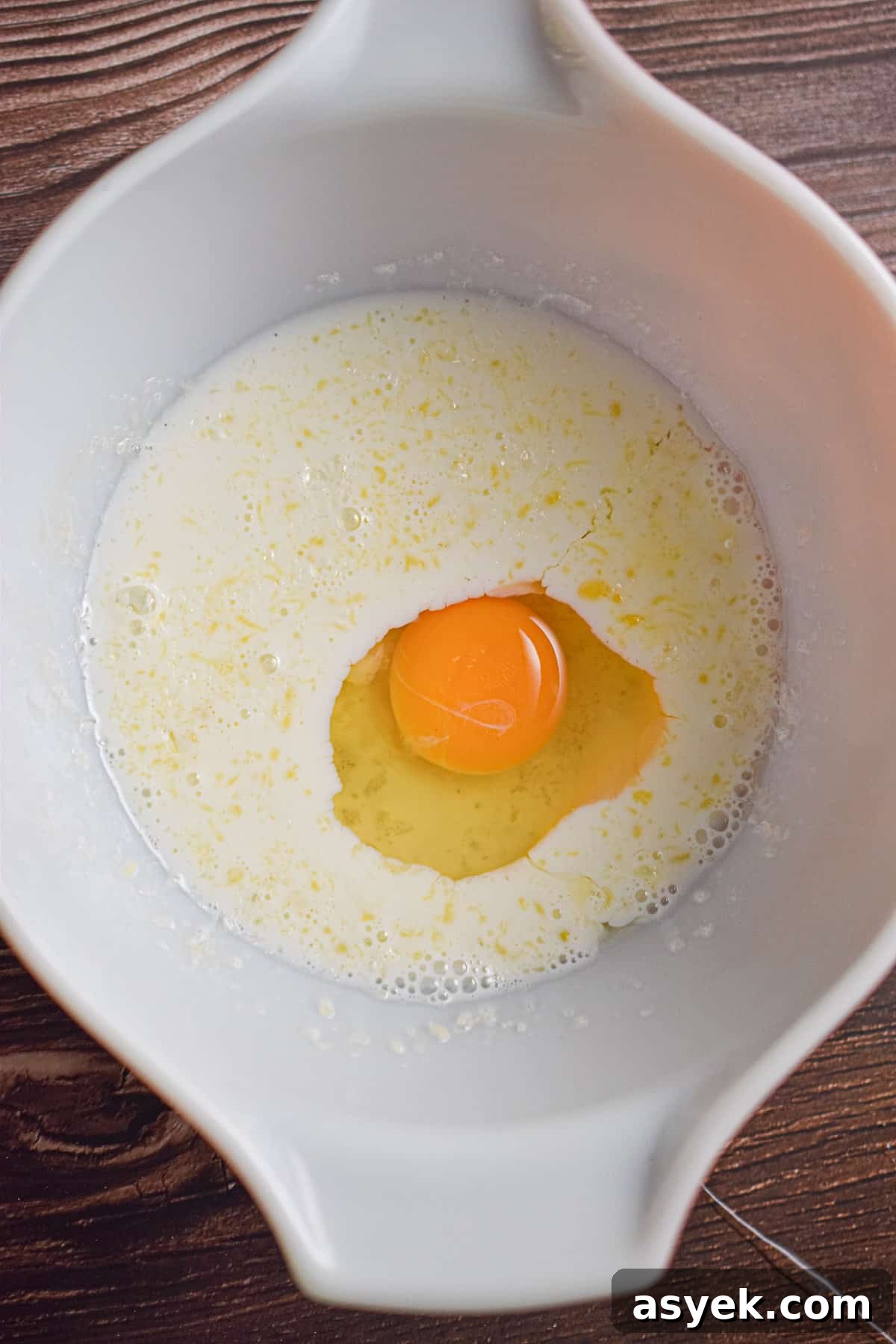 The egg is added to the large bowl.