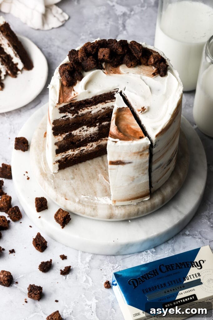 Fudgy Chocolate Brownie Cake Recipe 5 brownie cake on a marble board frosted with cream cheese frosting and topped with mini brownies