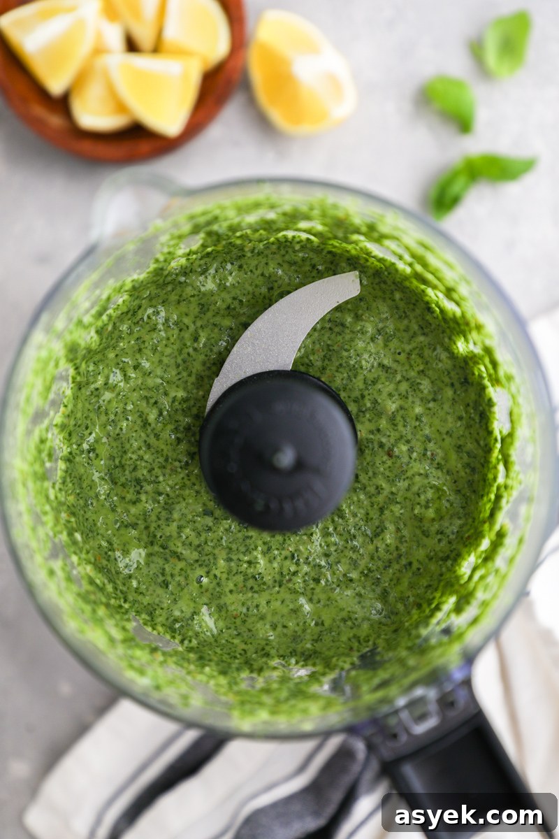 Kale Pesto Pasta with Homemade Pesto Sauce 4 A food processor photographed from above filled with a homemade kale pesto sauce