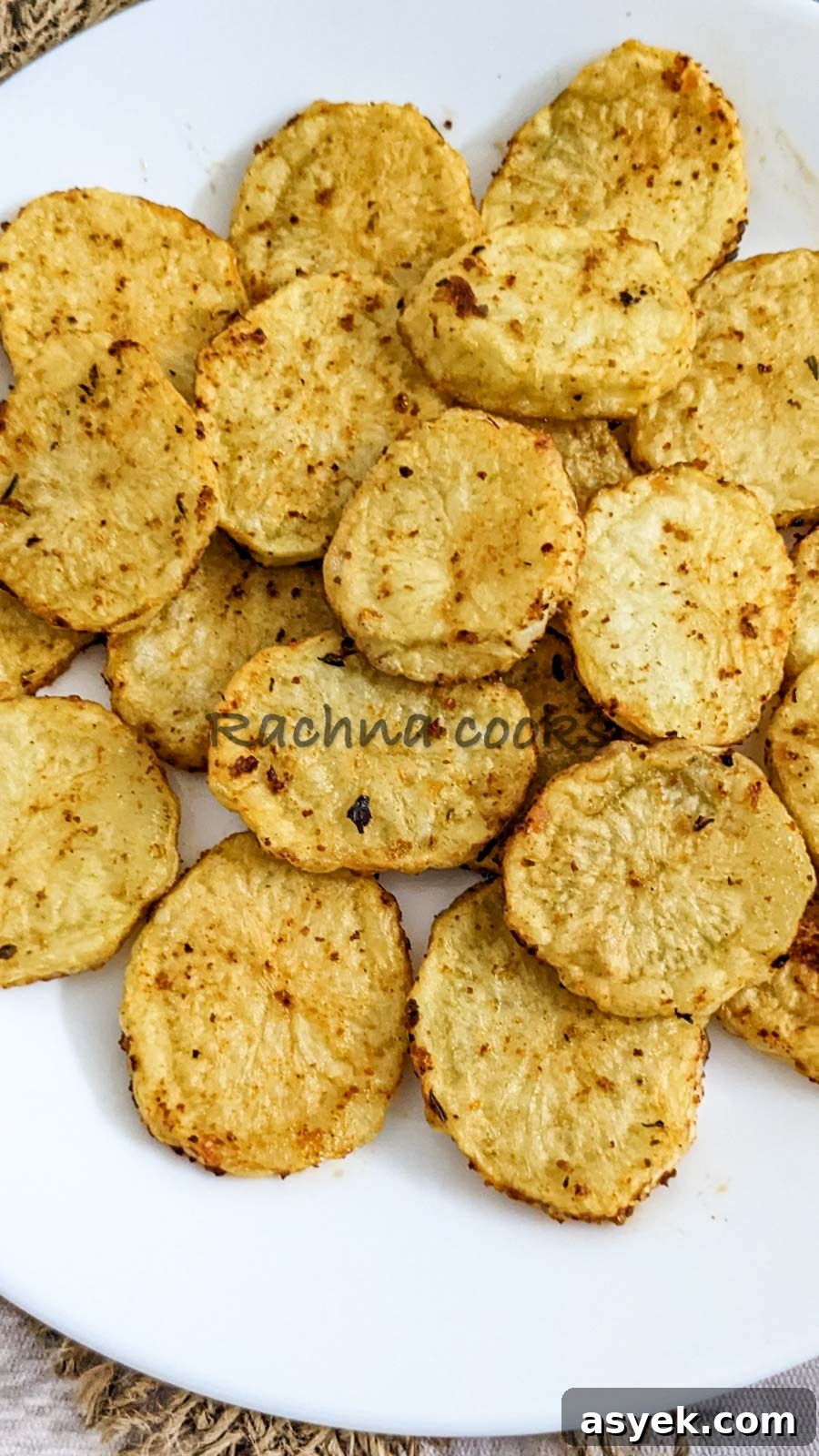 Crispy Air Fryer Potato Slices 3 close up of Air fried potato slices on a white plate.