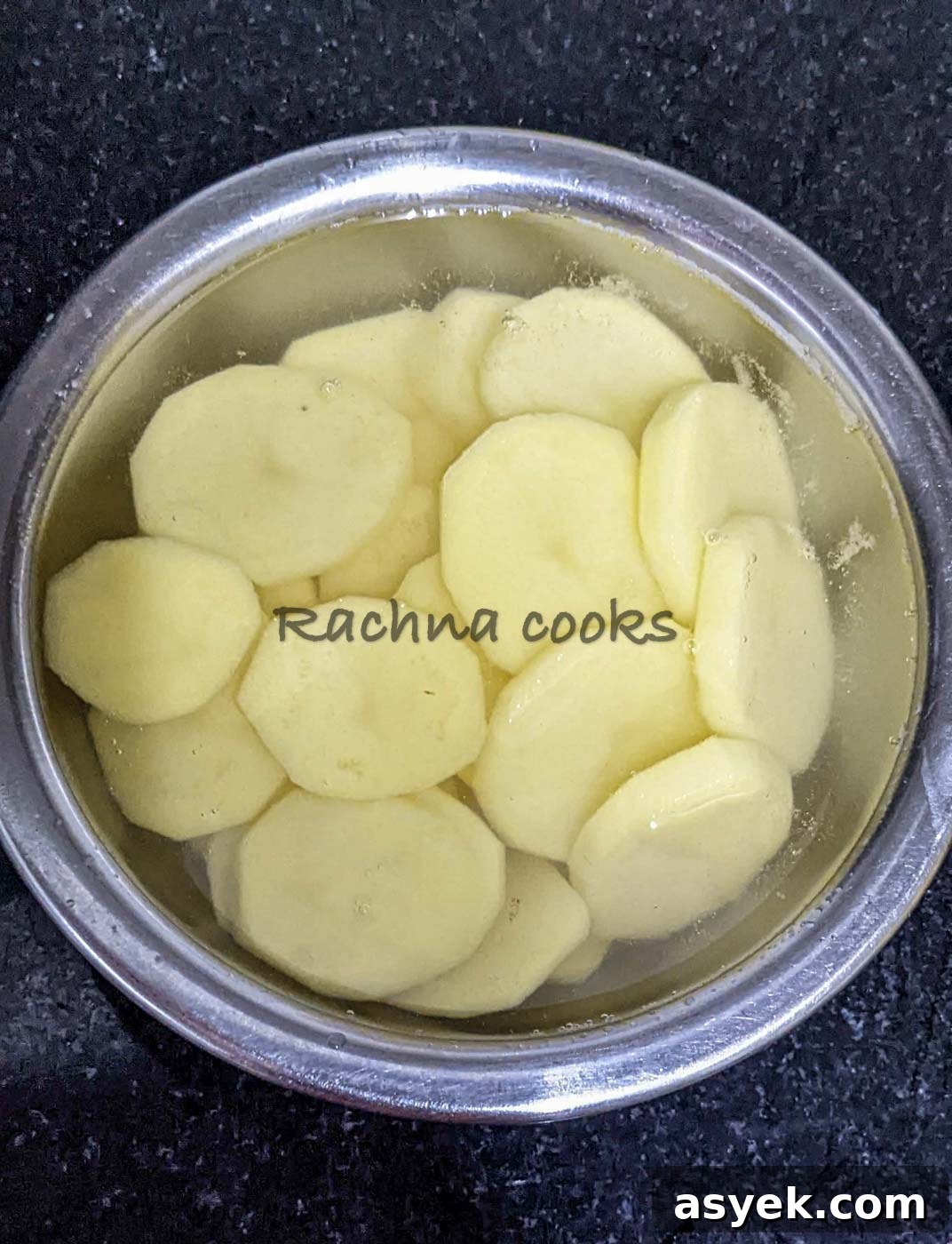 Crispy Air Fryer Potato Slices 5 Potato slices soaked in water in a bowl