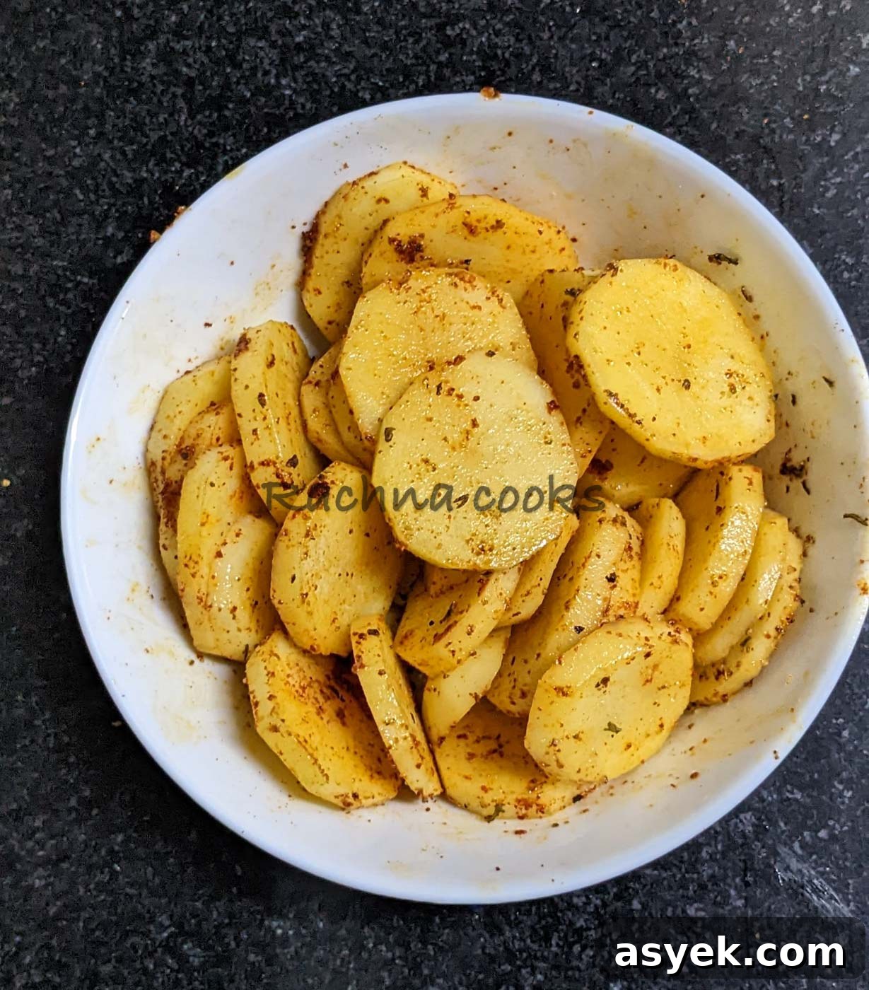 Crispy Air Fryer Potato Slices 7 Potato slices coated with oil and seasonings.