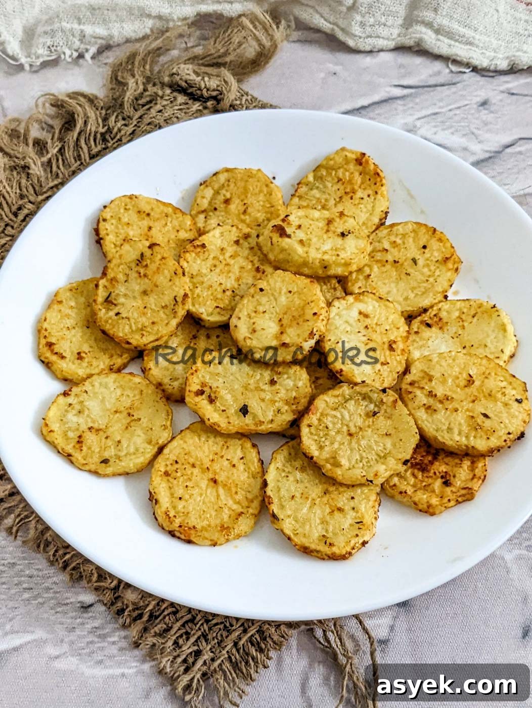 Crispy Air Fryer Potato Slices 10 Air fried potato slices on a white plate.