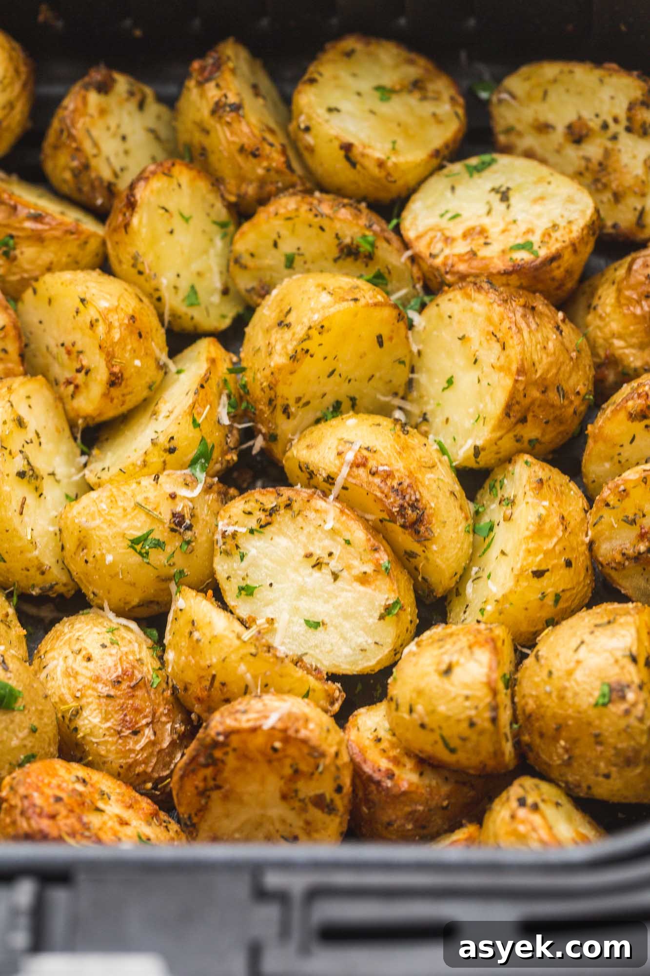 Crispy Air Fryer Roasted Potatoes 3 Roasted baby potatoes in an Air Fryer basket.
