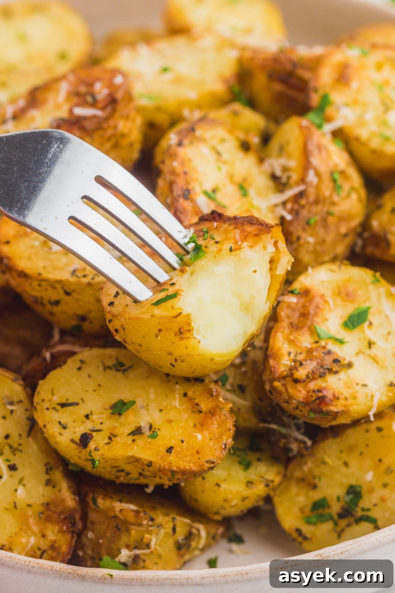 Crispy Air Fryer Roasted Potatoes 6 A bite shot of roasted potatoes with a fork