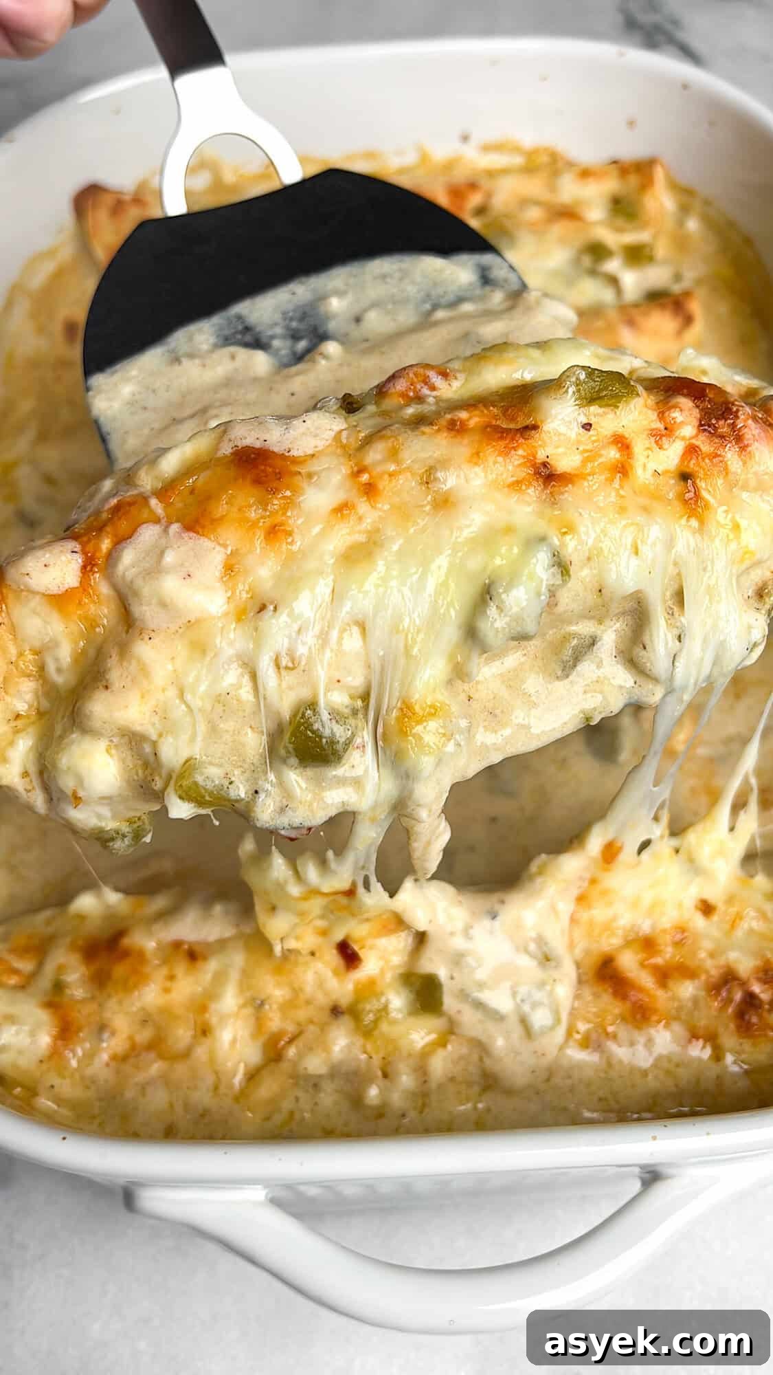 enchiladas baked in a pan and scooped out with a spatula