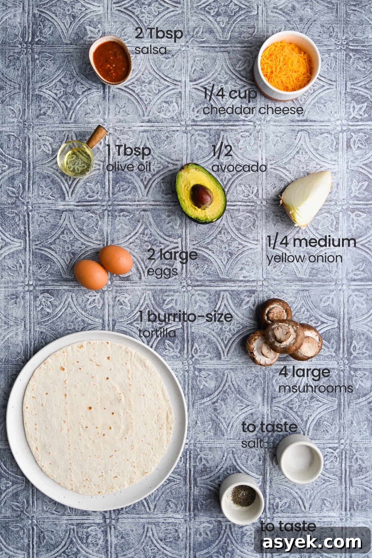 Vegetarian Breakfast Burrito Recipe with Avocado and Fresh Salsa 3 All ingredients for a vegetarian breakfast burrito including salsa, shredded cheddar cheese, olive oil, avocado, onion, eggs, mushrooms, flour tortilla, salt, and pepper.