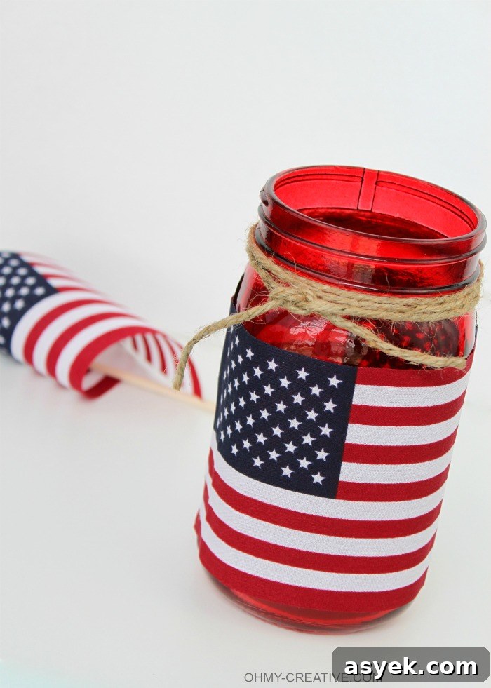 This Patriotic Flag Mason Jar Candle Holder Craft took me minutes to make. Great for a last minute patriotic party or picnic decoration and I love that it can also hold a bouquet of flowers…so many uses! | OHMY-CREATIVE.COM
