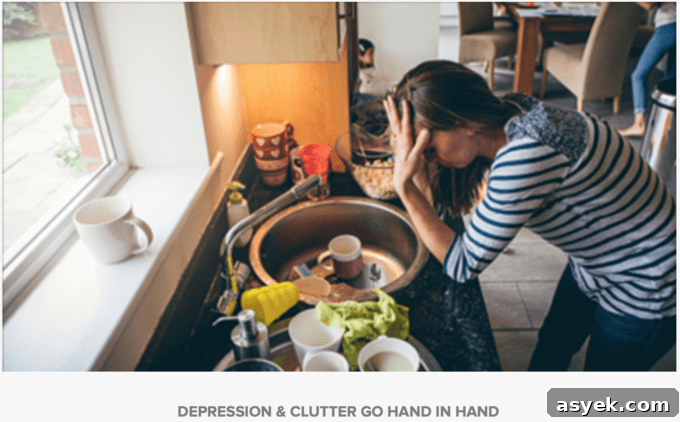 A woman leaning on a cluttered counter with her head in her hands.
