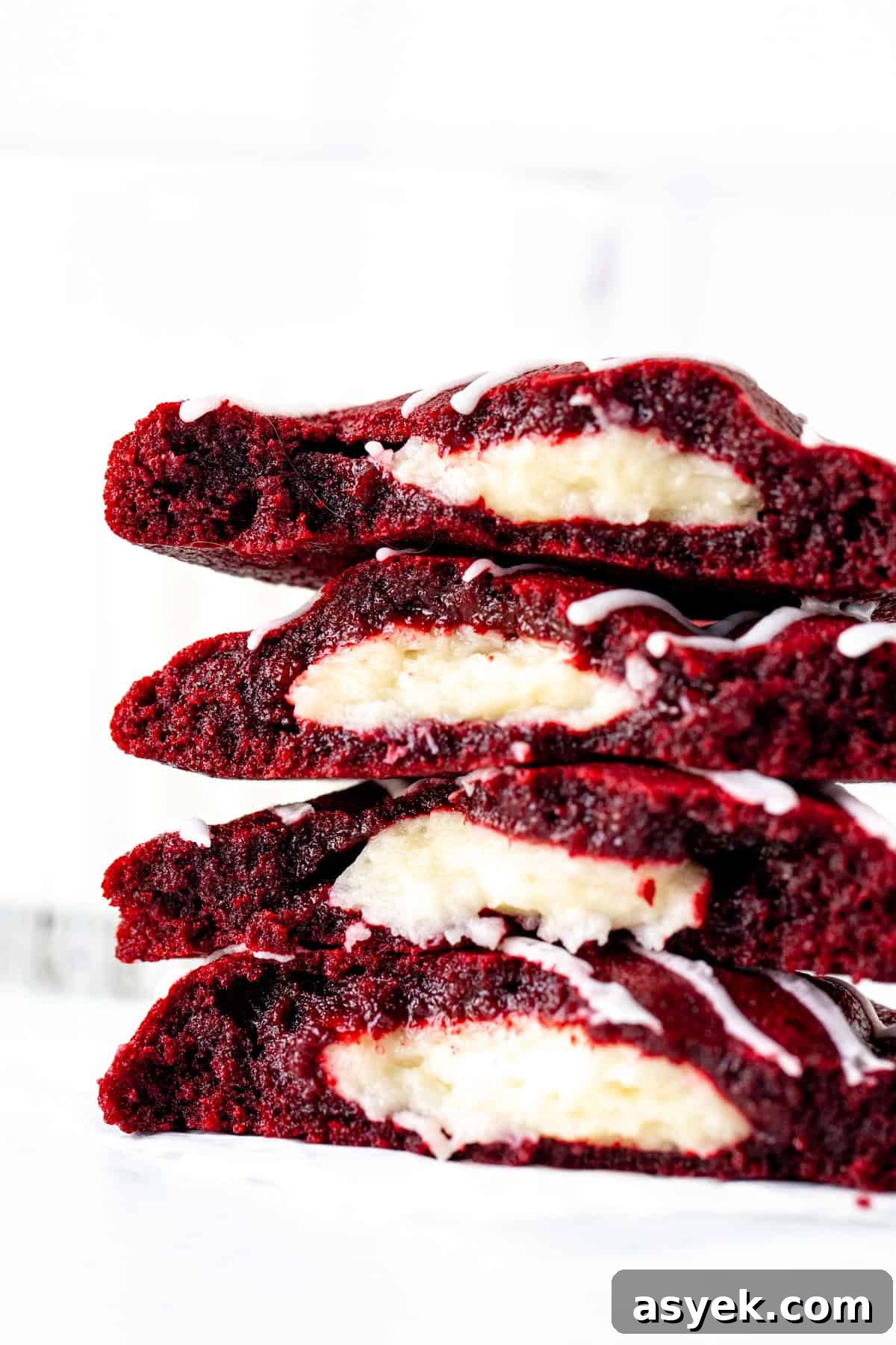 Red Velvet Cookies with Cream Cheese Filling 7 cheesecake stuffed red velvet cookies, broken in half and stacked on top of each other