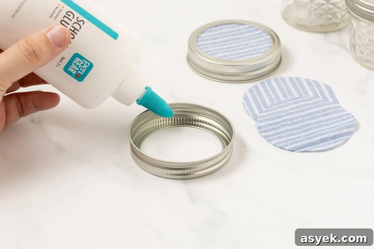 fabric circles being glued onto a mason jar ring