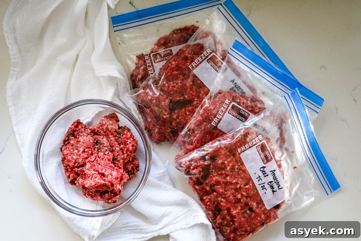 Ground beef with organ meat in a clear bowl and a freezer ziplock on the side.